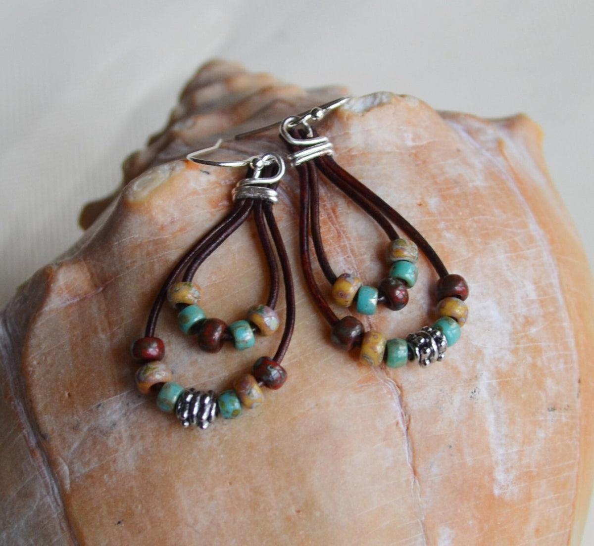 Pair of earrings with beads on a shell