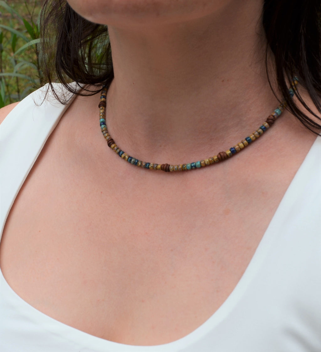 Necklace with multicolored beads worn by a person outdoors