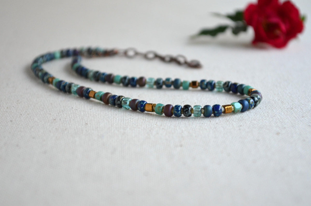 Beaded necklace on a white background with a red flower