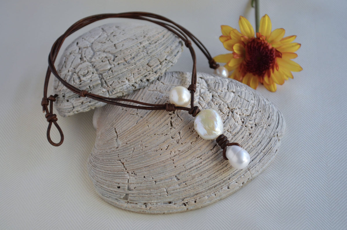 Necklace with pearls on a shell and yellow flower