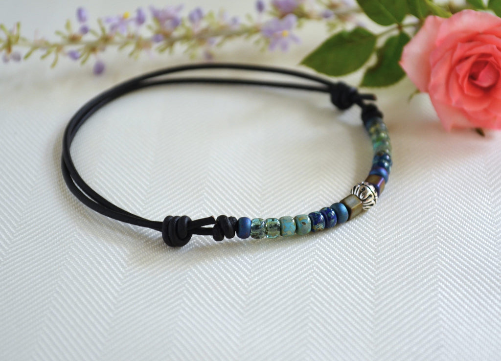 Beaded ankle bracelet on a white background with flowers