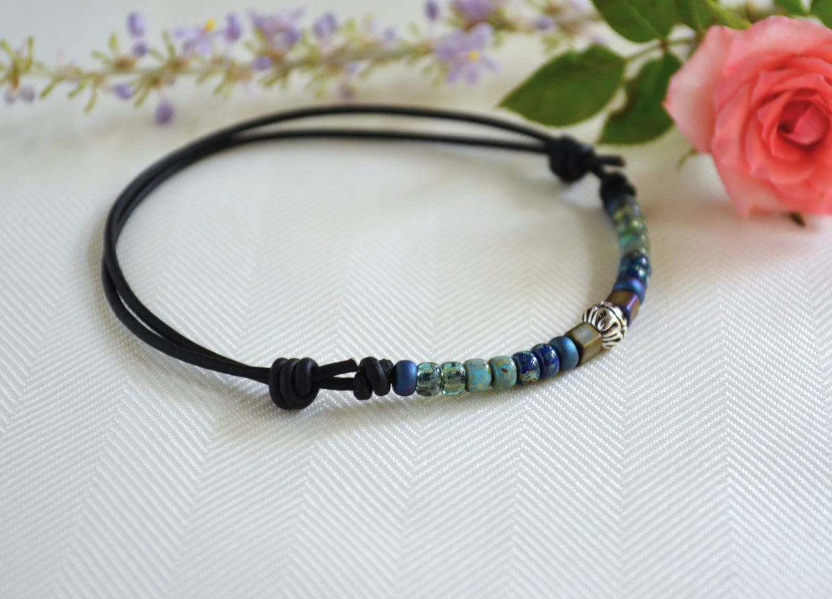Beaded ankle bracelet on a white background with flowers