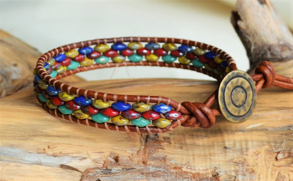 Multicolored beaded bracelet with a wooden button clasp on a wooden surface