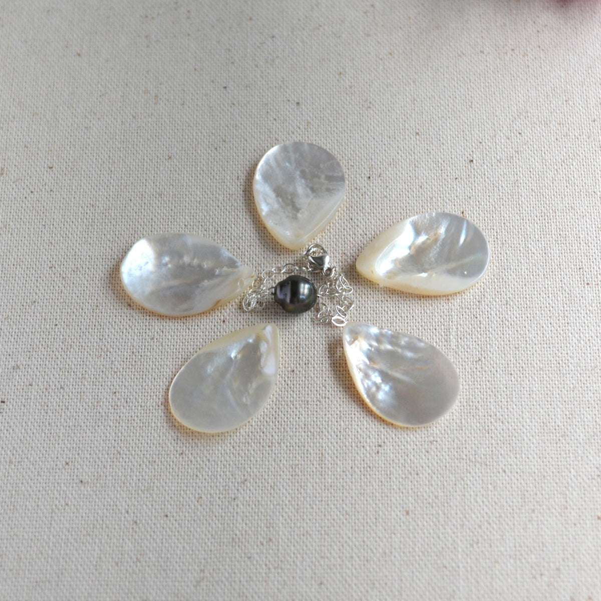 Tahitian pearl sterling silver chain bracelet centered in the middle of shells creating a flower