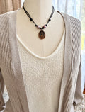 mannequin showcasing pink pearls on leather necklace with tree of life pendant