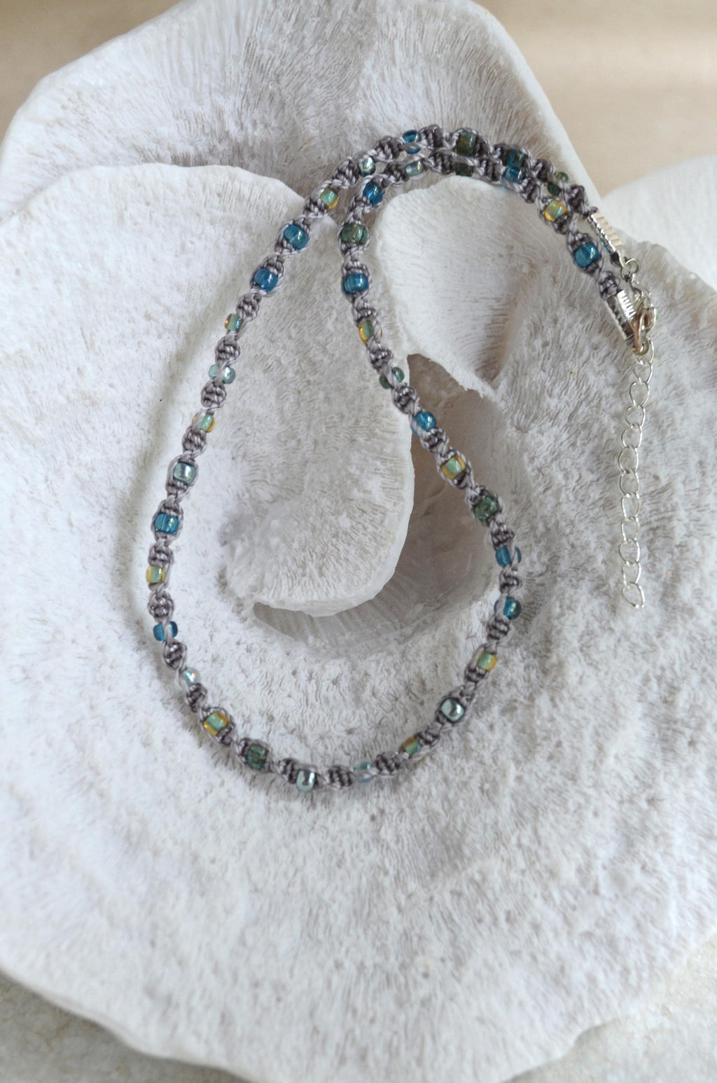 Beaded necklace on a white stone surface