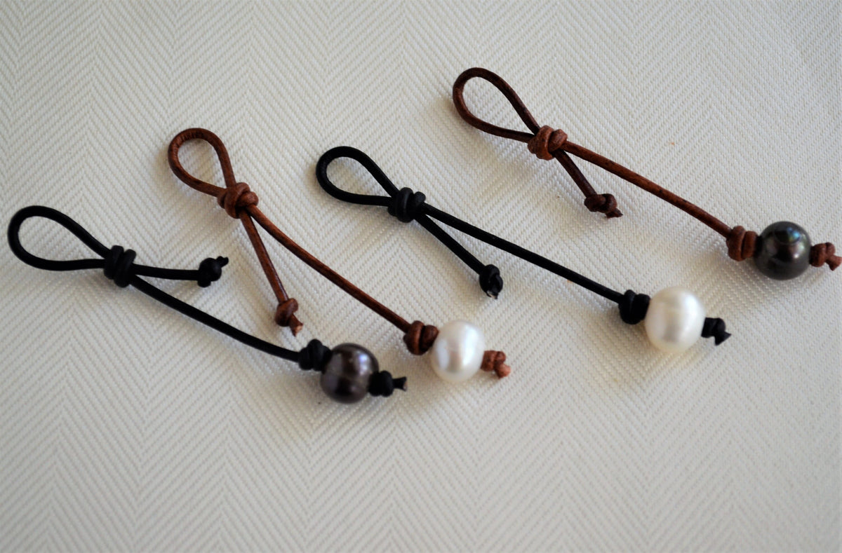 Four necklace/bracelet pearl leather extenders on a white background