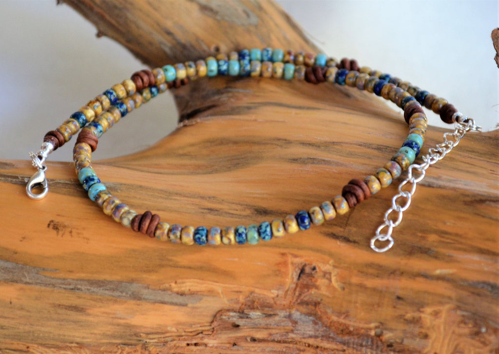 Beaded necklace with a chain on a wooden surface