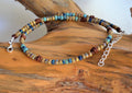 Beaded necklace with a chain on a wooden surface