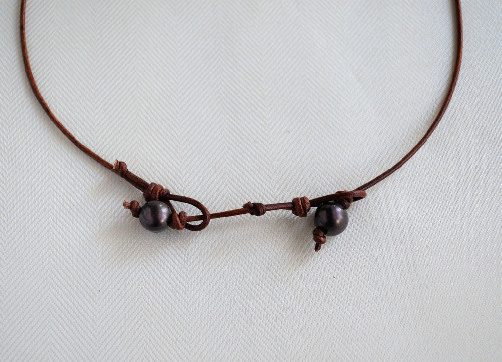 Necklace with pearl leather extender on a white background
