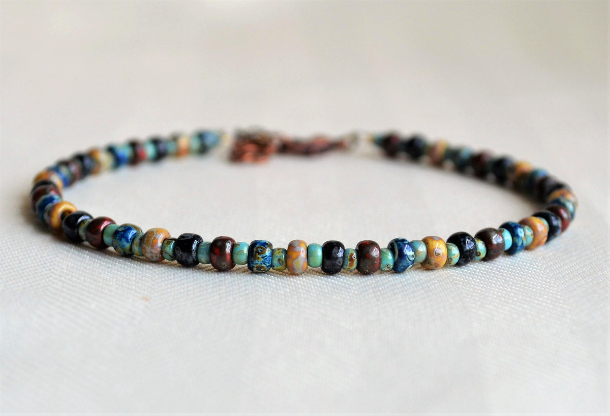 Beaded anklet with multicolor beads on a white background