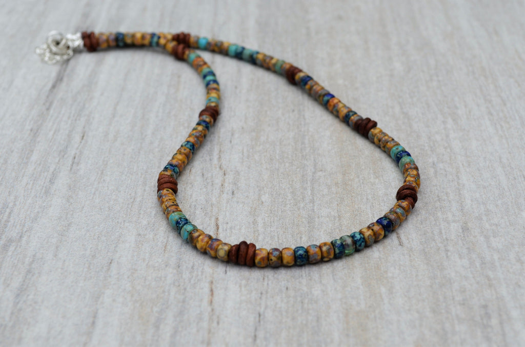 Beaded necklace with multicolor beads on a light wooden surface